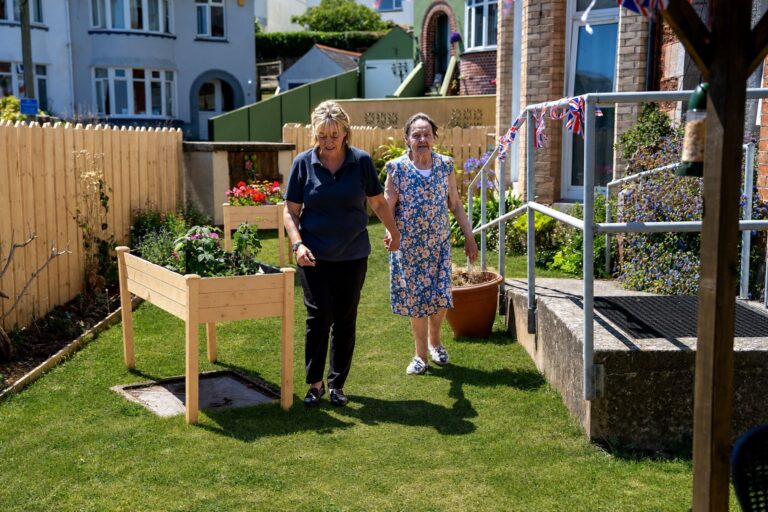 Residents and staff enjoying time together in Kingsmount's garden